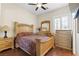 Cozy bedroom featuring a ceiling fan, hardwood floors and a light wood dresser at 10089 Clifton Forge Ave, Las Vegas, NV 89148
