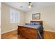 Bedroom showcasing hardwood floors, a window with shutters, and a comfortable bed at 10089 Clifton Forge Ave, Las Vegas, NV 89148