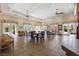 Spacious clubhouse interior with tables, chairs, and views of the outside garden at 10089 Clifton Forge Ave, Las Vegas, NV 89148