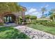 Beautifully landscaped entrance to the Southern Terrace Club with an arched entryway and lush greenery at 10089 Clifton Forge Ave, Las Vegas, NV 89148