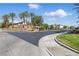 Community entrance featuring desert landscaping and well-maintained lawns, with a decorative stone monument at 10089 Clifton Forge Ave, Las Vegas, NV 89148
