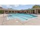 A serene community pool with comfortable lounge chairs and umbrellas for relaxation in a tranquil environment at 10089 Clifton Forge Ave, Las Vegas, NV 89148