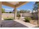 Covered patio with a ceiling fan, concrete flooring, and access to the landscaped backyard at 10089 Clifton Forge Ave, Las Vegas, NV 89148