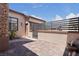 Paver patio with stone pillar, outdoor grill and gate at 10089 Clifton Forge Ave, Las Vegas, NV 89148