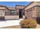 Exterior view showcases a desert landscaped home, with stone accents, an inviting front entrance, and a garage at 10089 Clifton Forge Ave, Las Vegas, NV 89148
