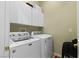 Laundry room featuring a front loading washer and dryer and storage cabinets at 10089 Clifton Forge Ave, Las Vegas, NV 89148