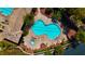 Aerial shot of the unique hourglass pool with surrounding lounge chairs and well-maintained landscaping at 10089 Clifton Forge Ave, Las Vegas, NV 89148