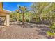 Low maintenance backyard with beautiful rock features, a palm tree, and lush plants providing a serene outdoor setting at 10314 Premia Pl, Las Vegas, NV 89135
