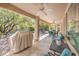 Relax on the spacious covered patio with ceiling fans, and outdoor furniture, perfect for entertaining or enjoying the serene outdoor space at 10314 Premia Pl, Las Vegas, NV 89135