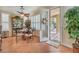 Bright dining room features a ceiling fan, tile floors and natural light from the sliding doors to the covered patio at 10314 Premia Pl, Las Vegas, NV 89135