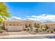 Charming single-story home with a well-manicured yard, desert landscaping, and a two-car garage at 10314 Premia Pl, Las Vegas, NV 89135