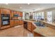 Modern kitchen with stainless appliances, granite countertops, island and tile floor at 10314 Premia Pl, Las Vegas, NV 89135