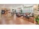 Open-concept living room connected to kitchen and dining with tile flooring, large windows, and ample seating at 10314 Premia Pl, Las Vegas, NV 89135
