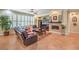 Comfortable living room featuring a fireplace, tile flooring, and lots of natural light at 10314 Premia Pl, Las Vegas, NV 89135