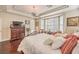 Well-lit main bedroom featuring hardwood floors, a ceiling fan, and charming bay window at 10314 Premia Pl, Las Vegas, NV 89135