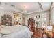 Comfortable main bedroom boasts hardwood floors, a ceiling fan, and access to the ensuite bathroom at 10314 Premia Pl, Las Vegas, NV 89135