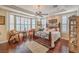 Inviting main bedroom features tray ceiling, ceiling fan, hardwood floors and large windows at 10314 Premia Pl, Las Vegas, NV 89135