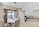 Bright dining area with sliding glass doors to the patio and open access to the living room at 10410 Nostalgia Cir, Las Vegas, NV 89135