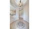 Inviting foyer with decorative tile inlay and arched doorways, enhanced by modern lighting fixture at 10410 Nostalgia Cir, Las Vegas, NV 89135