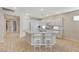 Bright kitchen with a large island, white cabinets, stainless appliances and seamless flow to other areas at 10410 Nostalgia Cir, Las Vegas, NV 89135