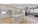 Modern kitchen with white cabinetry, stainless steel appliances, and an island with counter seating at 10410 Nostalgia Cir, Las Vegas, NV 89135