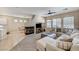 Open-concept living room featuring a cozy fireplace, plush seating, and tile flooring at 10410 Nostalgia Cir, Las Vegas, NV 89135