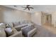 Spacious living room with a large sectional sofa, neutral decor, and plush carpeting at 10410 Nostalgia Cir, Las Vegas, NV 89135