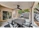 Covered patio area with a ceiling fan, table with chairs, a grill, and a view of the backyard at 10410 Nostalgia Cir, Las Vegas, NV 89135
