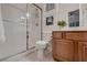 Bathroom features a glass-enclosed shower, white tile and a wood vanity with white marble countertop at 11345 Espadrille Ct, Las Vegas, NV 89138