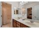 Well-lit bathroom featuring dual sinks, a tub/shower combo, and modern fixtures at 11345 Espadrille Ct, Las Vegas, NV 89138