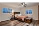 Comfortable bedroom with wood-look flooring, a large window with shutters, and a cozy bed at 11345 Espadrille Ct, Las Vegas, NV 89138