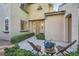 Charming front entrance with a cozy seating area, beautiful landscaping, and a welcoming pathway to the home at 11345 Espadrille Ct, Las Vegas, NV 89138