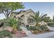 Inviting home entrance with landscaped steps and a decorative iron security door, surrounded by lush, manicured greenery at 11345 Espadrille Ct, Las Vegas, NV 89138