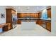 Bright kitchen with stainless steel appliances, granite counters, wood cabinets, and tile flooring at 11345 Espadrille Ct, Las Vegas, NV 89138