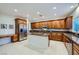 Spacious kitchen featuring stainless steel appliances, central island, and wood cabinets at 11345 Espadrille Ct, Las Vegas, NV 89138