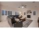 Bright living room showcases a fireplace, a ceiling fan and comfortable seating at 11345 Espadrille Ct, Las Vegas, NV 89138