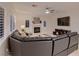 Spacious living room boasts a fireplace, plantation shutters, and a large leather sectional at 11345 Espadrille Ct, Las Vegas, NV 89138