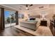 Relaxing main bedroom features a plush bed, balcony access, and custom window shutters at 11345 Espadrille Ct, Las Vegas, NV 89138