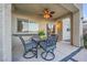 Covered patio with an outdoor dining set and view of the manicured backyard at 11345 Espadrille Ct, Las Vegas, NV 89138