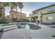 Resort-style pool area with attached spa, covered patio and second story balcony, ideal for luxurious outdoor living at 11345 Espadrille Ct, Las Vegas, NV 89138