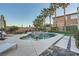 Private backyard with a sparkling pool, spa, lush greenery, and serene ambiance, creating an oasis of relaxation at 11345 Espadrille Ct, Las Vegas, NV 89138