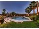 Beautiful backyard featuring a swimming pool, hot tub, desert landscaping, and privacy wall at 11345 Espadrille Ct, Las Vegas, NV 89138