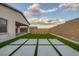 Backyard has a great space with a high brick wall and artificial turf with concrete pavers at 11617 Peregrine Point Ct, Las Vegas, NV 89138
