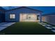 Beautiful backyard featuring artificial grass, modern pavers, and direct views into the kitchen at 11617 Peregrine Point Ct, Las Vegas, NV 89138