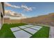 Backyard features an easy to maintain design with artificial grass and concrete pavers at 11617 Peregrine Point Ct, Las Vegas, NV 89138
