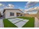 Backyard showcasing artificial turf with concrete tiles and a covered patio at 11617 Peregrine Point Ct, Las Vegas, NV 89138