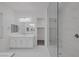 Bright bathroom featuring tiled shower and vanity with a mirror and a white countertop at 11617 Peregrine Point Ct, Las Vegas, NV 89138