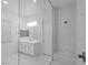 Modern bathroom with a tiled shower, large mirror, and vanity with white cabinets and double sinks at 11617 Peregrine Point Ct, Las Vegas, NV 89138