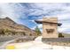 Falcon Crest community entrance with desert landscaping, mountain backdrop, and a modern sign at 11617 Peregrine Point Ct, Las Vegas, NV 89138