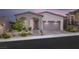 Charming single-story home featuring desert landscaping, an arched entryway, and a spacious two-car garage at 11617 Peregrine Point Ct, Las Vegas, NV 89138